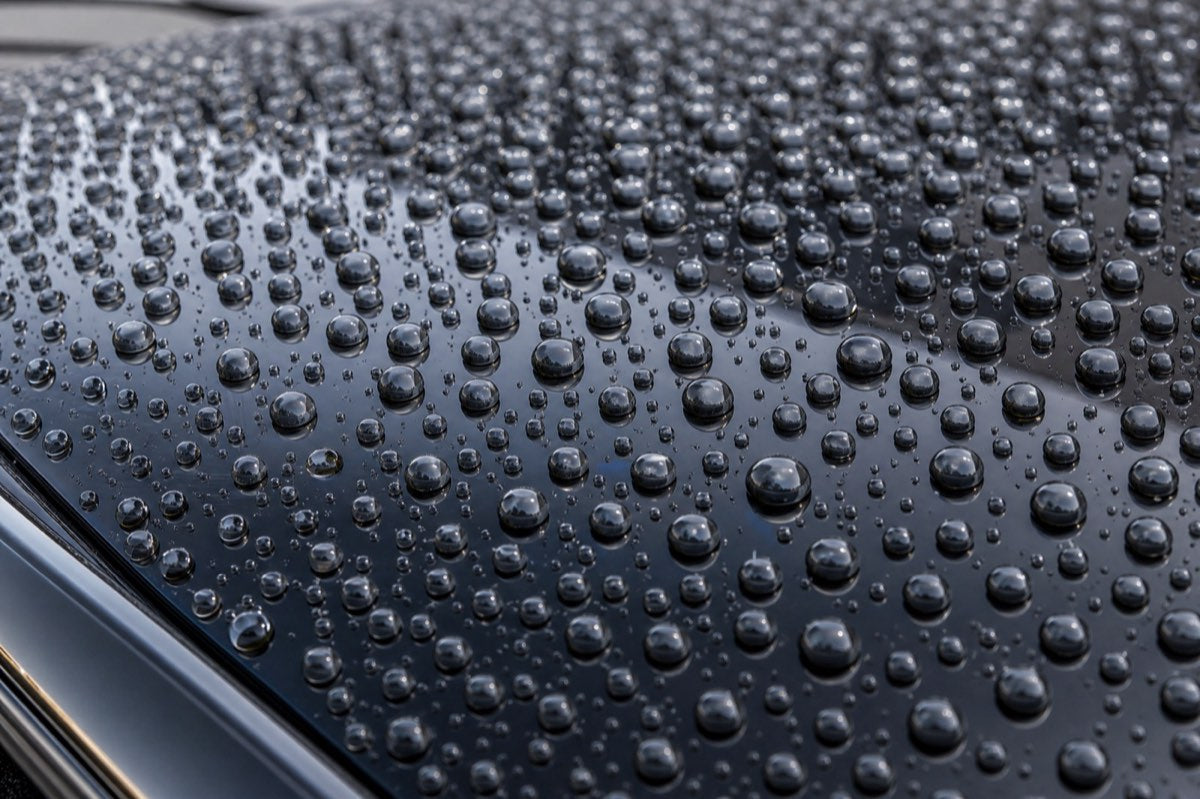 Water beading into tight spheres on a glossy graphene-coated car hood