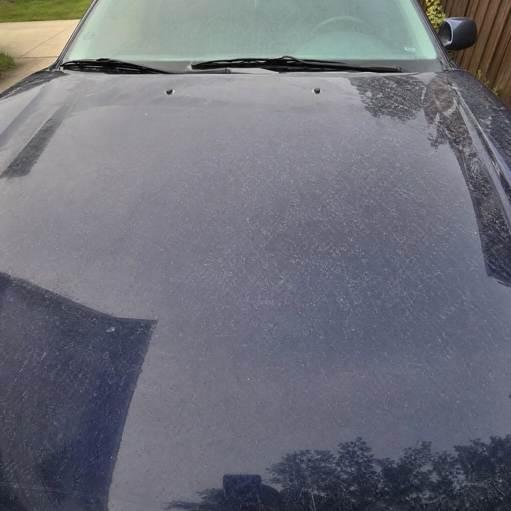 Faded, water-spotted car hood before ceramic protection